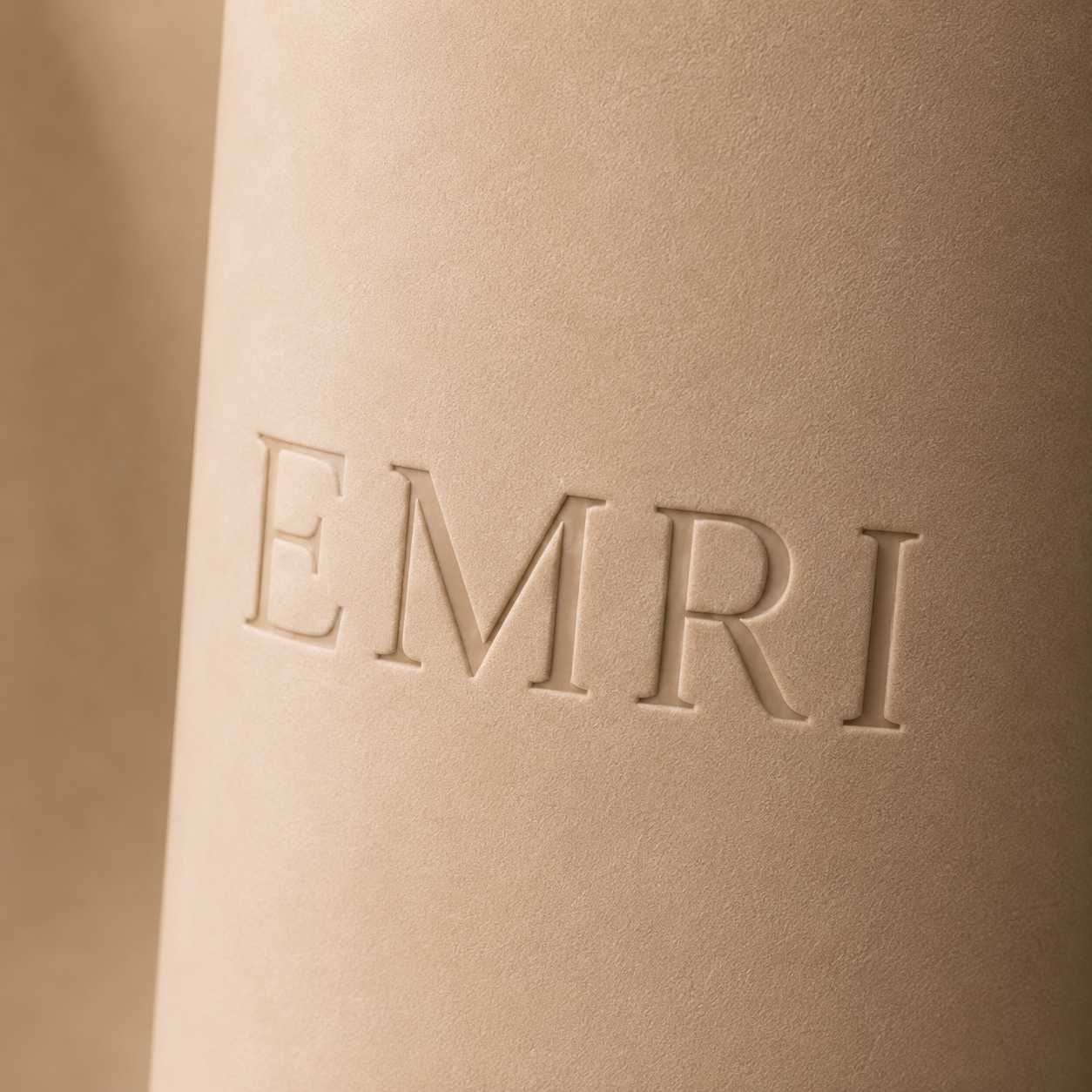 Debossed EMRI wordmark
